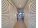 Hallway with white louvered doors and view of bedroom at 6 Belleview Blvd # 105, Belleair, FL 33756