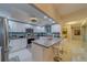 Modern white kitchen with stainless steel appliances and breakfast bar at 6 Belleview Blvd # 105, Belleair, FL 33756