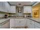 Modern white kitchen with sink and ample counter space at 6 Belleview Blvd # 105, Belleair, FL 33756