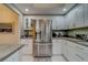 Stainless steel refrigerator in modern white kitchen at 6 Belleview Blvd # 105, Belleair, FL 33756