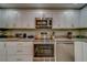 Stainless steel range and microwave in modern white kitchen at 6 Belleview Blvd # 105, Belleair, FL 33756