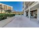 Outdoor patio with table and chairs, partial ocean view at 6 Belleview Blvd # 105, Belleair, FL 33756