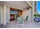 Cozy patio with seating area adjacent to sliding glass doors at 6 Belleview Blvd # 105, Belleair, FL 33756