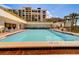 Inviting community pool with lounge chairs at 6 Belleview Blvd # 105, Belleair, FL 33756