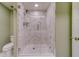 Large walk-in shower with glass enclosure and marble tile at 6 Belleview Blvd # 105, Belleair, FL 33756