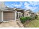Tan colored house with brown garage door and well manicured lawn at 9404 Rockbridge Cir # 9404, New Port Richey, FL 34655