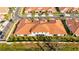 Aerial view of townhome with tile roof and landscaping at 17554 Holly Well Ave, Wimauma, FL 33598