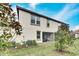 Home's back elevation, screened patio, and fenced yard at 17554 Holly Well Ave, Wimauma, FL 33598