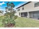 Landscaped backyard with a view of the screened patio at 17554 Holly Well Ave, Wimauma, FL 33598