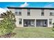 Screened patio and grassy backyard with privacy fence at 17554 Holly Well Ave, Wimauma, FL 33598