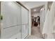 Bathroom with a walk-in shower, modern finishes, and a large closet at 17554 Holly Well Ave, Wimauma, FL 33598