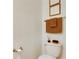 Small bathroom with toilet and tan towels at 17554 Holly Well Ave, Wimauma, FL 33598