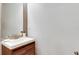 Modern bathroom with wood vanity and a large mirror at 17554 Holly Well Ave, Wimauma, FL 33598