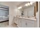 Double vanity bathroom with a walk-in shower and modern finishes at 17554 Holly Well Ave, Wimauma, FL 33598