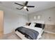 Bright bedroom with a queen bed, ceiling fan, and double doors leading to the closet at 17554 Holly Well Ave, Wimauma, FL 33598