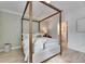 Serene bedroom featuring a canopy bed and plenty of closet space at 17554 Holly Well Ave, Wimauma, FL 33598