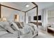 Main bedroom with a comfortable canopy bed and ensuite bathroom at 17554 Holly Well Ave, Wimauma, FL 33598