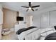 Modern bedroom with wood-like flooring, a dresser, and a large TV at 17554 Holly Well Ave, Wimauma, FL 33598