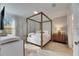 Spacious bedroom with a canopy bed and plenty of natural light at 17554 Holly Well Ave, Wimauma, FL 33598