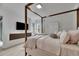 Light and airy bedroom with a canopy bed and built-in shelving at 17554 Holly Well Ave, Wimauma, FL 33598