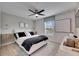 Bright bedroom with a comfy bed and large window at 17554 Holly Well Ave, Wimauma, FL 33598