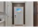 Modern entryway with white door and dark brown accent wall at 17554 Holly Well Ave, Wimauma, FL 33598