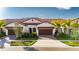 Tan two-story home with brown garage door at 17554 Holly Well Ave, Wimauma, FL 33598