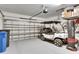 Garage with golf cart, bicycle, and overhead storage at 17554 Holly Well Ave, Wimauma, FL 33598