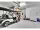 Spacious garage with golf cart, storage racks, and a punching bag at 17554 Holly Well Ave, Wimauma, FL 33598