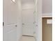 Clean hallway with neutral paint and tile flooring at 17554 Holly Well Ave, Wimauma, FL 33598