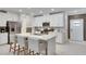 Modern kitchen with white cabinets and island at 17554 Holly Well Ave, Wimauma, FL 33598