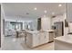 Open concept kitchen with island and stainless steel appliances at 17554 Holly Well Ave, Wimauma, FL 33598