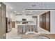 Modern kitchen with white cabinets and a large island at 17554 Holly Well Ave, Wimauma, FL 33598