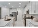 Modern kitchen with white cabinets and stainless steel appliances at 17554 Holly Well Ave, Wimauma, FL 33598
