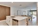 Open concept kitchen with island and white cabinets at 17554 Holly Well Ave, Wimauma, FL 33598