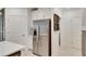 Modern kitchen features stainless steel appliances and white cabinetry at 17554 Holly Well Ave, Wimauma, FL 33598