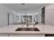 Kitchen island with stainless steel sink and modern faucet at 17554 Holly Well Ave, Wimauma, FL 33598