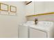 White washer and dryer in well-lit laundry room at 17554 Holly Well Ave, Wimauma, FL 33598