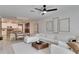 Spacious living room with white sectional sofa and wood coffee table at 17554 Holly Well Ave, Wimauma, FL 33598