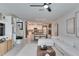 Open living room and kitchen with white sectional sofa at 17554 Holly Well Ave, Wimauma, FL 33598