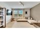Spacious living room featuring a sectional sofa and large windows with natural light at 17554 Holly Well Ave, Wimauma, FL 33598