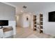 Bright loft area with built-in shelving and TV at 17554 Holly Well Ave, Wimauma, FL 33598