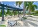 Poolside lounge area with pergola and seating at 17554 Holly Well Ave, Wimauma, FL 33598