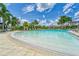 Relaxing pool area with a sandy beach entry at 17554 Holly Well Ave, Wimauma, FL 33598