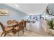 Bright dining area with glass table and wicker chairs, and ocean view at 3806 Gulf Of Mexico Dr # C211, Longboat Key, FL 34228