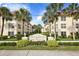 Beach Harbor Club condo building, featuring a welcoming entryway and landscaping at 3806 Gulf Of Mexico Dr # C211, Longboat Key, FL 34228
