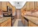 Well-equipped kitchen featuring granite counters and stainless steel appliances at 3806 Gulf Of Mexico Dr # C211, Longboat Key, FL 34228