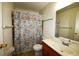 Bathroom with floral shower curtain and wood vanity at 4315 Aegean Dr # 110C, Tampa, FL 33611