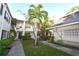 Exterior view of condo building with lush landscaping and walkways at 4315 Aegean Dr # 110C, Tampa, FL 33611