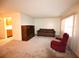 Living room with brown sofa, recliner, and wood entertainment center at 4315 Aegean Dr # 110C, Tampa, FL 33611